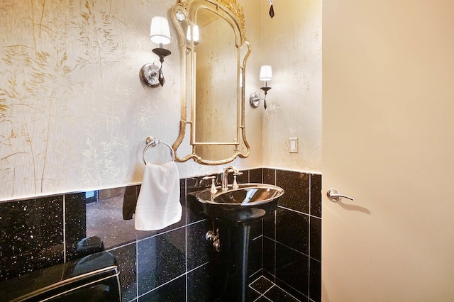 bathroom with tile walls and sink