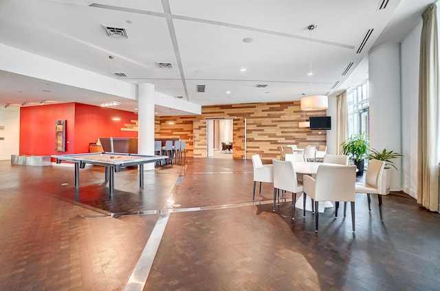 playroom featuring wooden walls and wood-type flooring