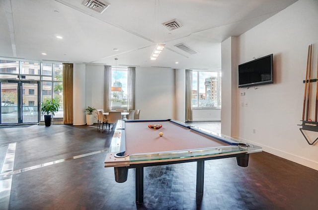 recreation room with dark hardwood / wood-style flooring, billiards, a healthy amount of sunlight, and expansive windows