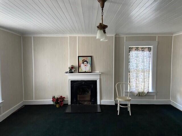 unfurnished living room with crown molding