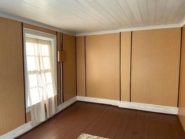 spare room featuring wooden ceiling and wood-type flooring