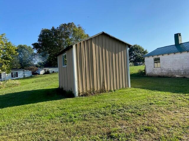 view of outbuilding with a lawn