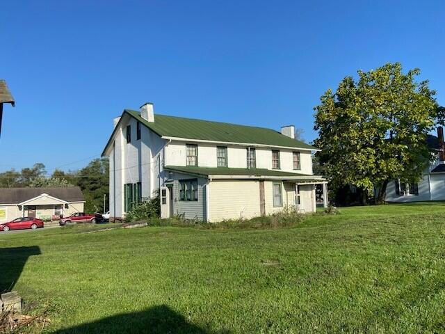 rear view of house with a yard