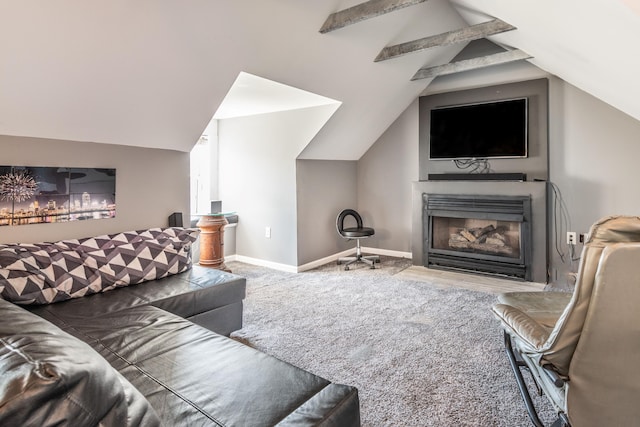 living room with baseboards, a glass covered fireplace, and vaulted ceiling
