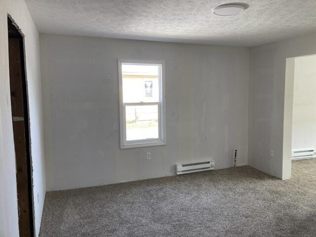 unfurnished room featuring a textured ceiling, baseboard heating, and carpet flooring