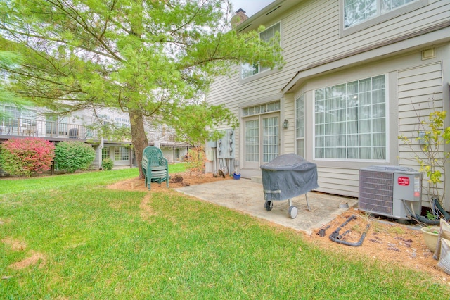 view of yard with central air condition unit and a patio area