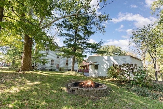 view of yard with an outdoor fire pit