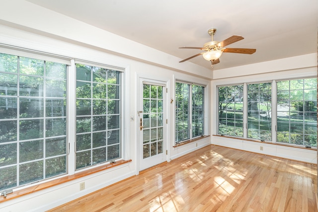 unfurnished sunroom featuring a healthy amount of sunlight and ceiling fan