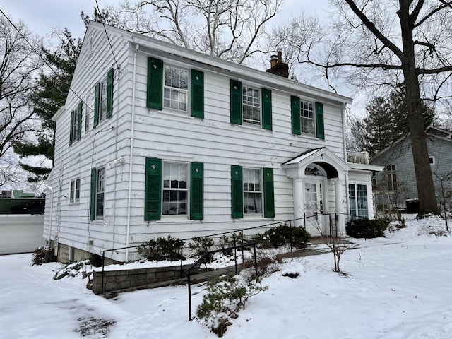 colonial home featuring a chimney