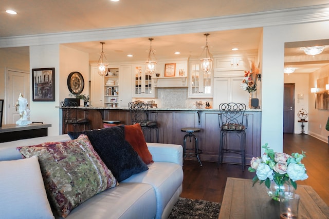 living room with dark wood-type flooring and crown molding