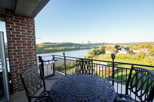 balcony featuring a water view and grilling area