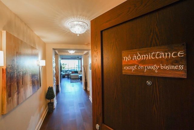 corridor featuring a chandelier and hardwood / wood-style floors