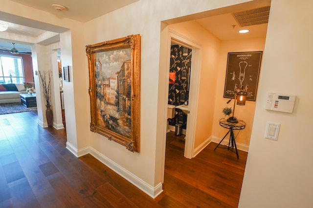 corridor with dark hardwood / wood-style flooring