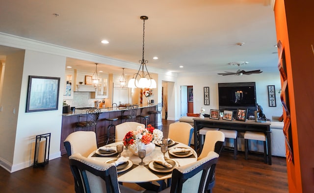 dining area featuring ornamental molding, ceiling fan with notable chandelier, and dark hardwood / wood-style flooring