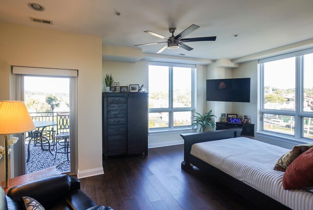 bedroom featuring ceiling fan, access to outside, dark hardwood / wood-style flooring, and multiple windows