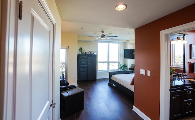 bedroom with ceiling fan, dark wood-type flooring, and sink