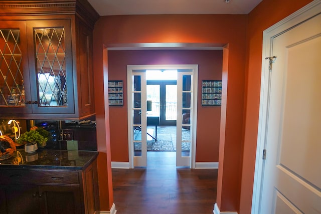 corridor featuring french doors and dark hardwood / wood-style floors