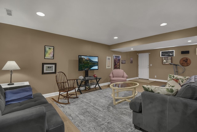 living room featuring recessed lighting, light wood-style floors, visible vents, and baseboards