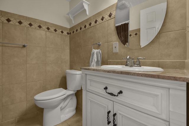 bathroom featuring vanity, tile walls, toilet, and tile patterned flooring