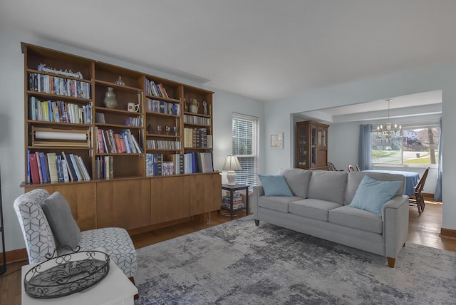 living area with an inviting chandelier and wood finished floors