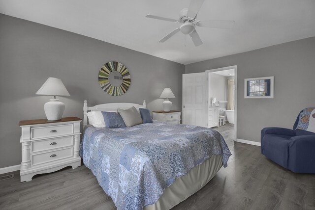 bedroom featuring ensuite bathroom, baseboards, wood finished floors, and a ceiling fan