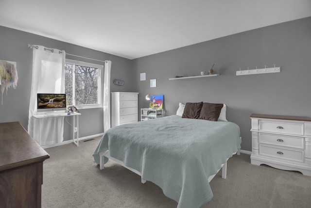 carpeted bedroom with visible vents and baseboards