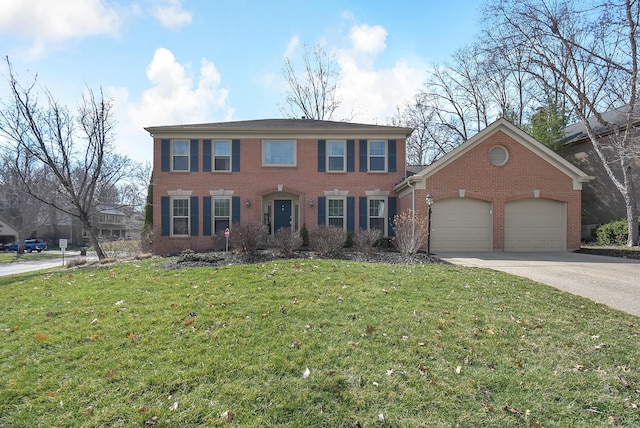 colonial home with brick siding, concrete driveway, a garage, and a front yard