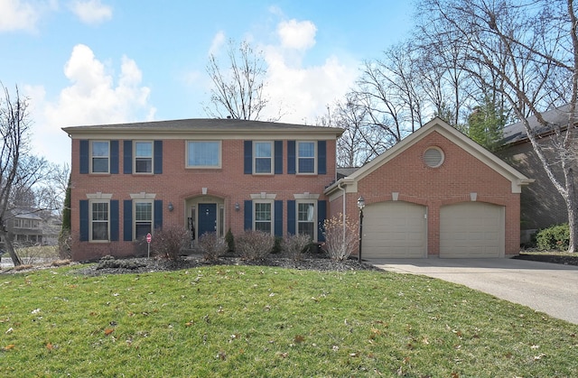 colonial home featuring brick siding, driveway, an attached garage, and a front lawn