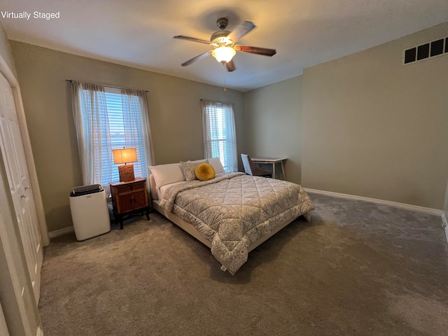 bedroom featuring ceiling fan, carpet, and a closet