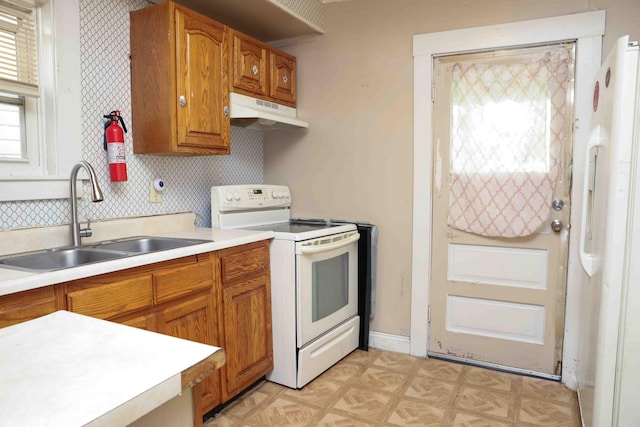 kitchen with white electric range oven, sink, and backsplash