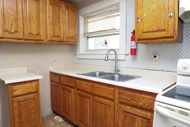 kitchen with ventilation hood, sink, electric range, and decorative backsplash