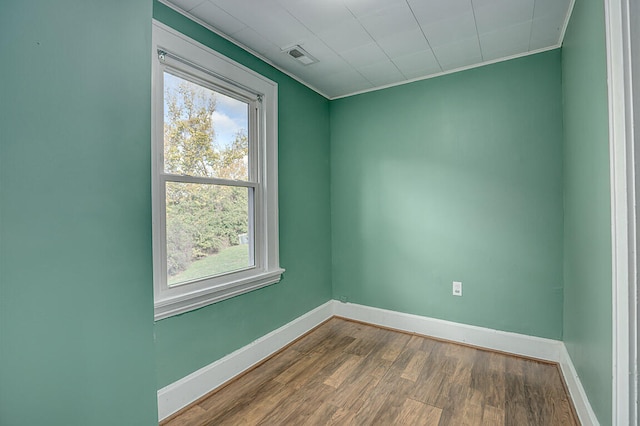 spare room featuring ornamental molding and hardwood / wood-style floors