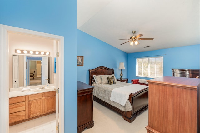 bedroom featuring ensuite bath, ceiling fan, and sink