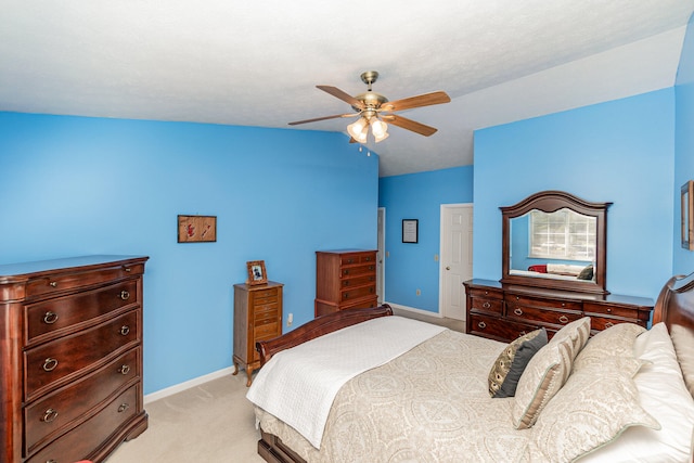 bedroom with ceiling fan, light carpet, and vaulted ceiling