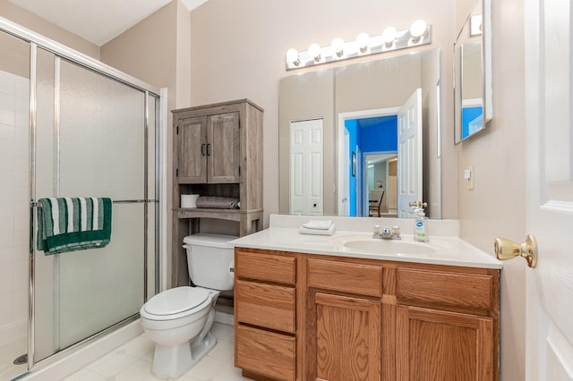 bathroom featuring tile patterned floors, vanity, toilet, and an enclosed shower