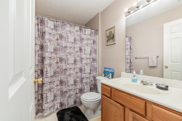 bathroom with toilet, vanity, a textured ceiling, and tile patterned floors