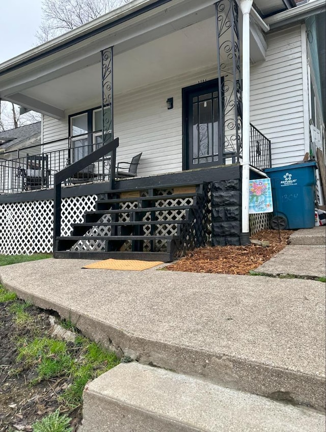 view of exterior entry featuring covered porch