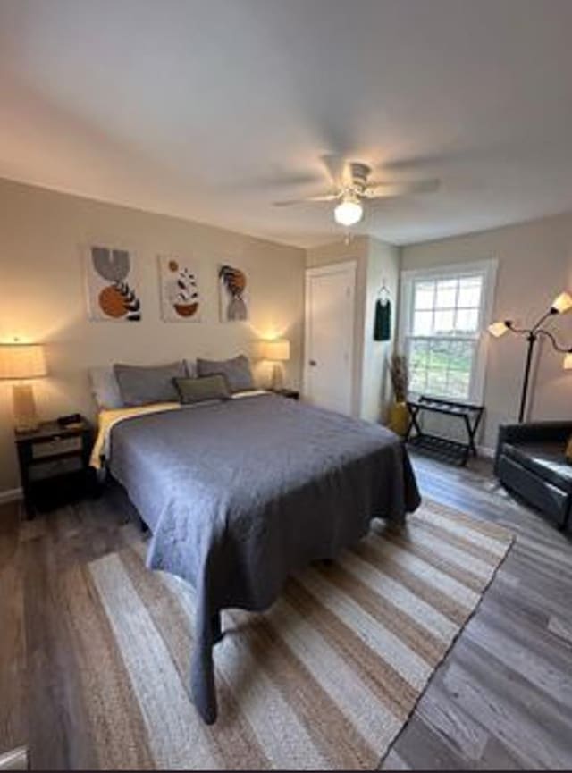 bedroom featuring hardwood / wood-style floors and ceiling fan