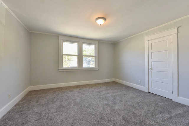 carpeted empty room featuring crown molding