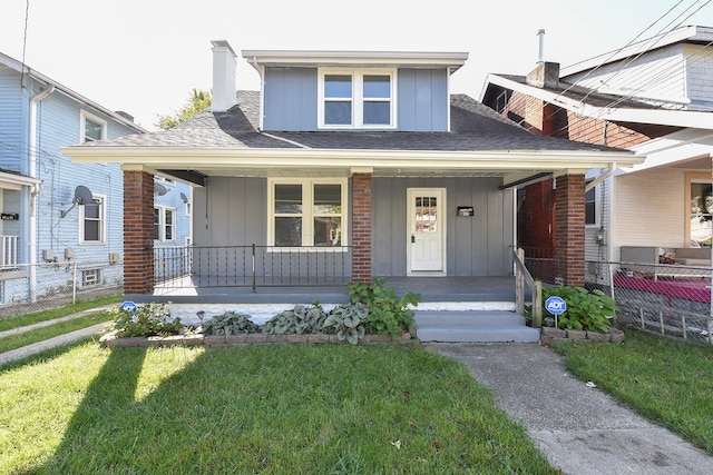 view of front of home featuring covered porch and a front yard