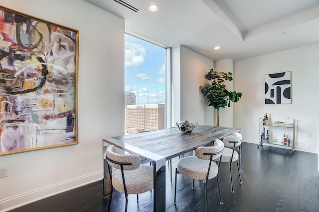 dining room featuring dark wood-type flooring and floor to ceiling windows