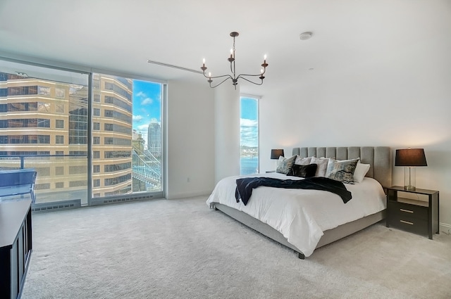 bedroom with a notable chandelier and carpet floors