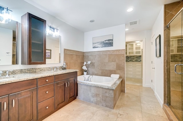 bathroom with vanity and separate shower and tub