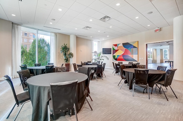 dining room with light carpet and a healthy amount of sunlight