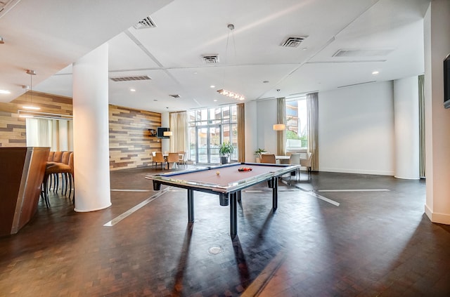 game room featuring billiards and wooden walls