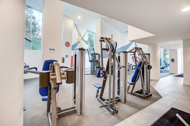 exercise room with light tile patterned flooring