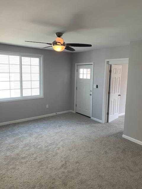 unfurnished room featuring carpet flooring and ceiling fan