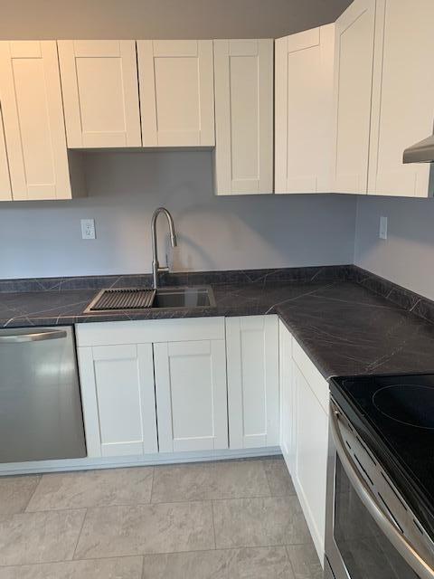 kitchen featuring white cabinetry, sink, and appliances with stainless steel finishes