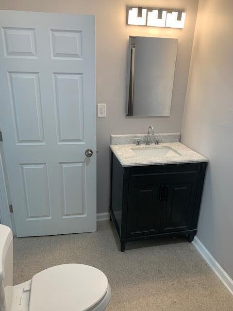 bathroom featuring vanity and toilet