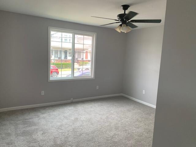 carpeted empty room with ceiling fan